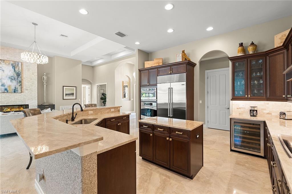 7400 Byrons Way Naples, FL 34113 - Photo 17 of 50 a kitchen with stainless steel appliances granite countertop a stove and a refrigerator