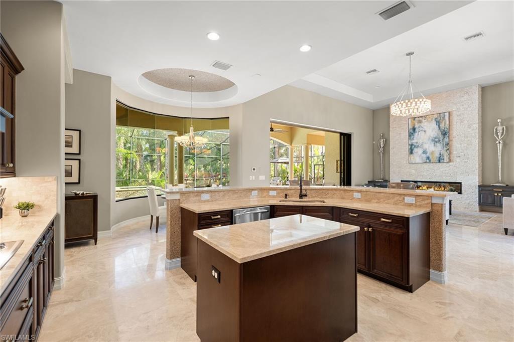 7400 Byrons Way Naples, FL 34113 - Photo 18 of 50 a kitchen with a stove and a sink