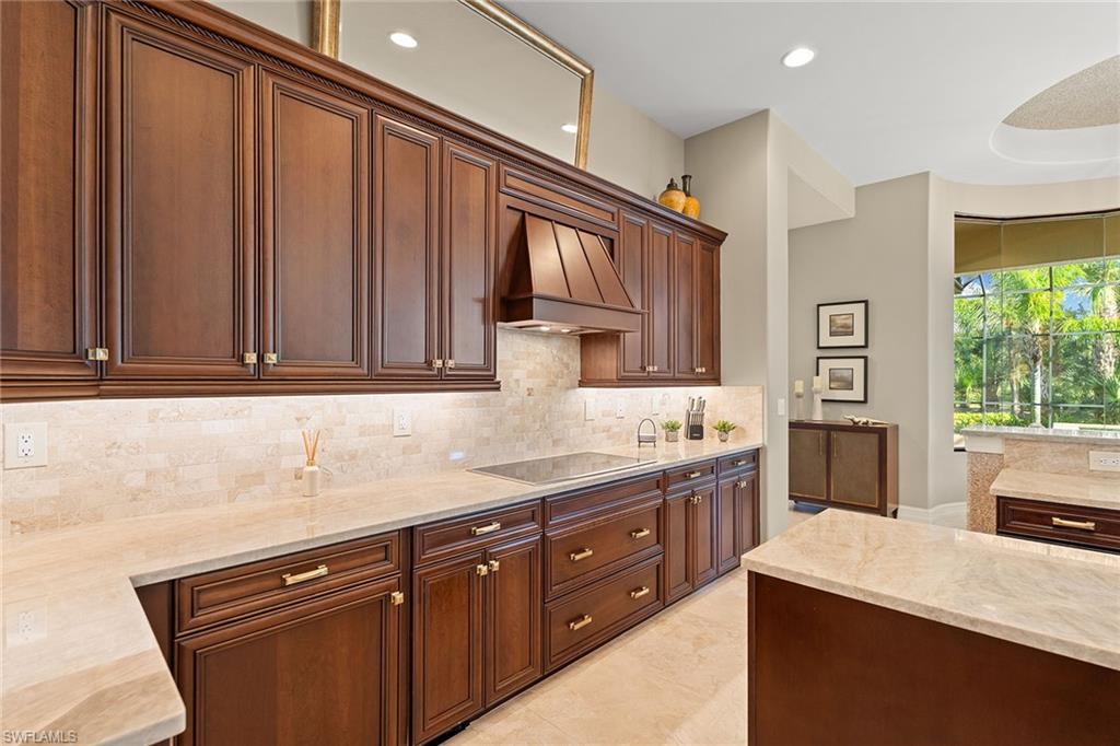 7400 Byrons Way Naples, FL 34113 - Photo 19 of 50 a kitchen with stainless steel appliances granite countertop a sink stove and cabinets