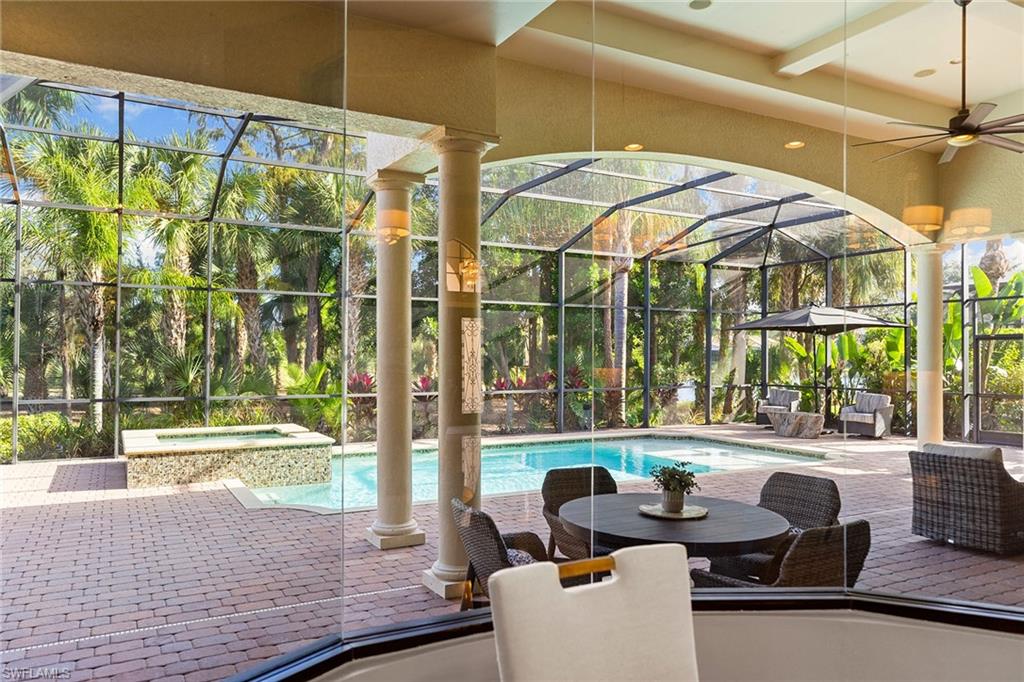 7400 Byrons Way Naples, FL 34113 - Photo 21 of 50 a outdoor space with patio the couches and pool table and chairs