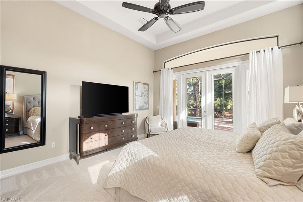 7400 Byrons Way Naples, FL 34113 - Photo 35 of 50 a bedroom with a bed and a flat screen tv