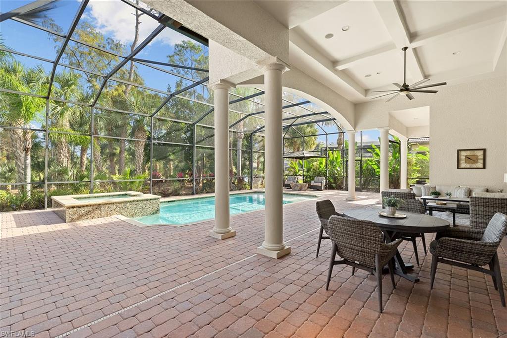 7400 Byrons Way Naples, FL 34113 - Photo 39 of 50 a view of a patio with table and chairs and wooden floor