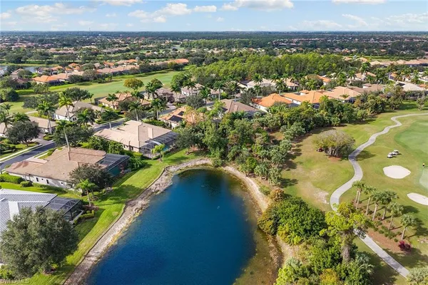 an aerial view of residential houses with outdoor space and river