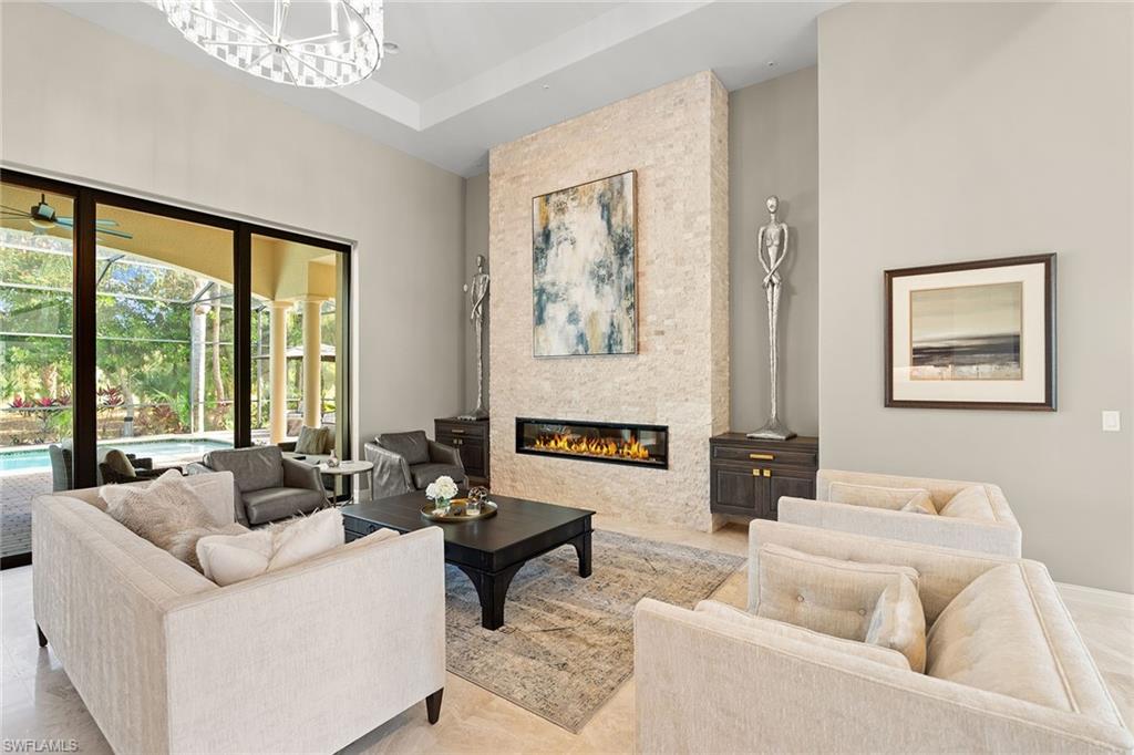 7400 Byrons Way Naples, FL 34113 - Photo 5 of 50 a living room with furniture and a large window