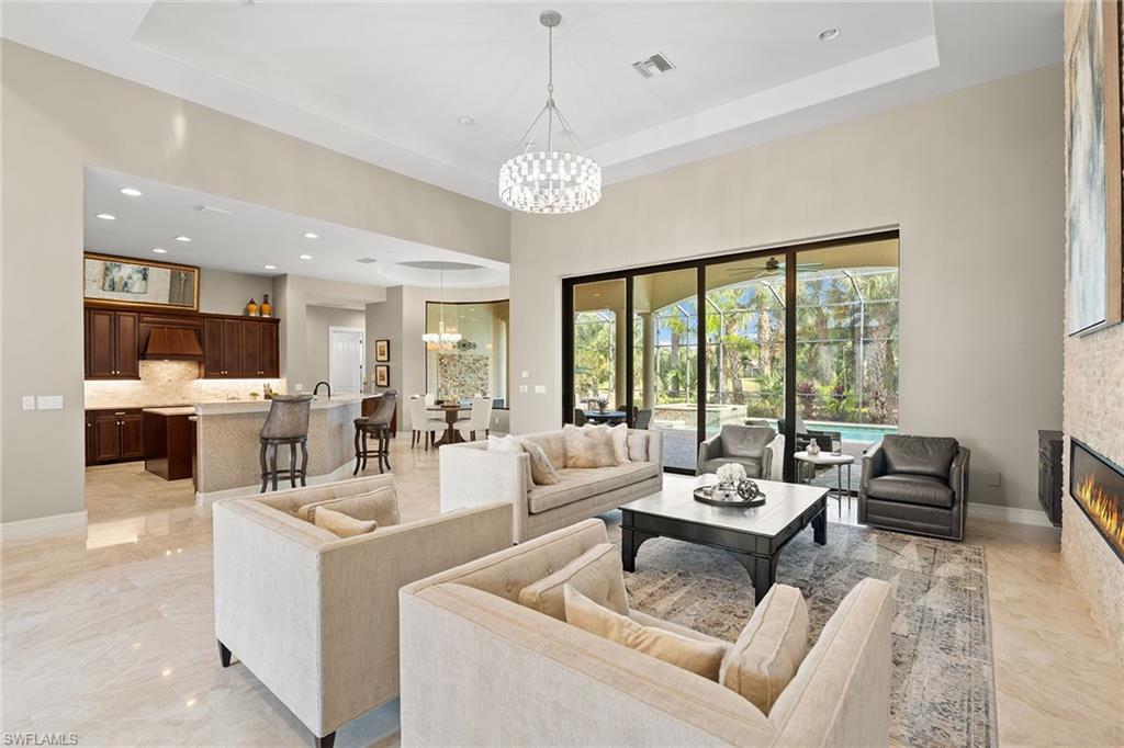 7400 Byrons Way Naples, FL 34113 - Photo 6 of 50 a living room with furniture and a large window