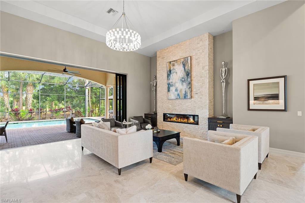 7400 Byrons Way Naples, FL 34113 - Photo 7 of 50 a living room with furniture and a large window