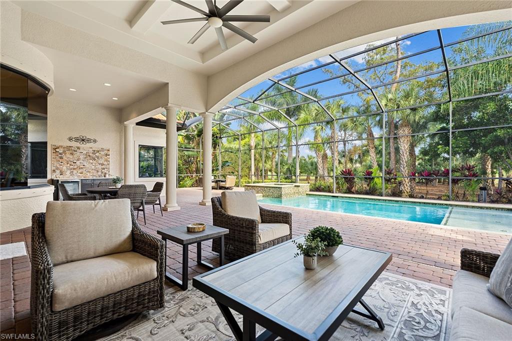 7400 Byrons Way Naples, FL 34113 - Photo 9 of 50 a living room with furniture and a large window