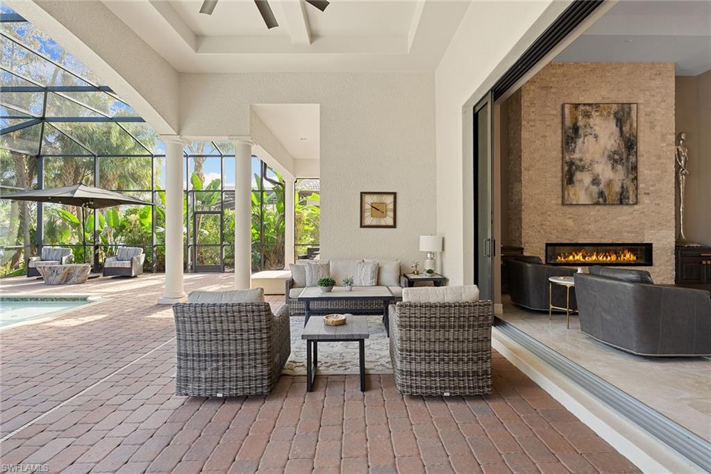 7400 Byrons Way Naples, FL 34113 - Photo 10 of 50 a living room with furniture and a large window