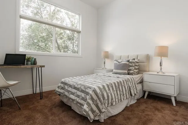 a bedroom with a bed and a window