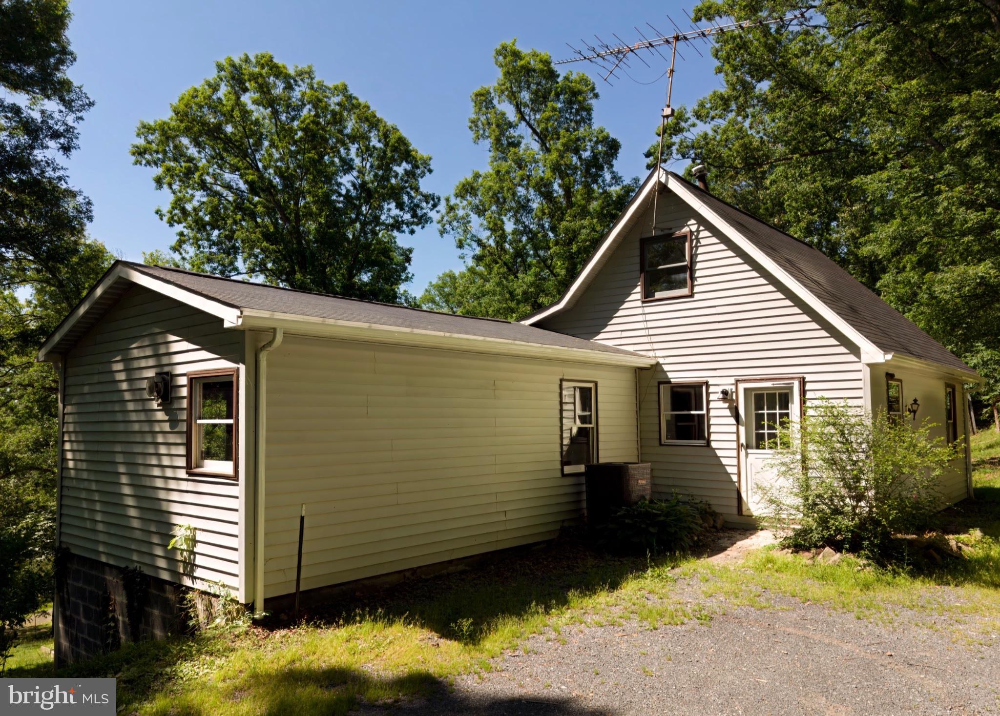 2932 Kerns School Road Springfield, WV 26763 - Photo 31 of 35 Charming home nestled in lush greenery.