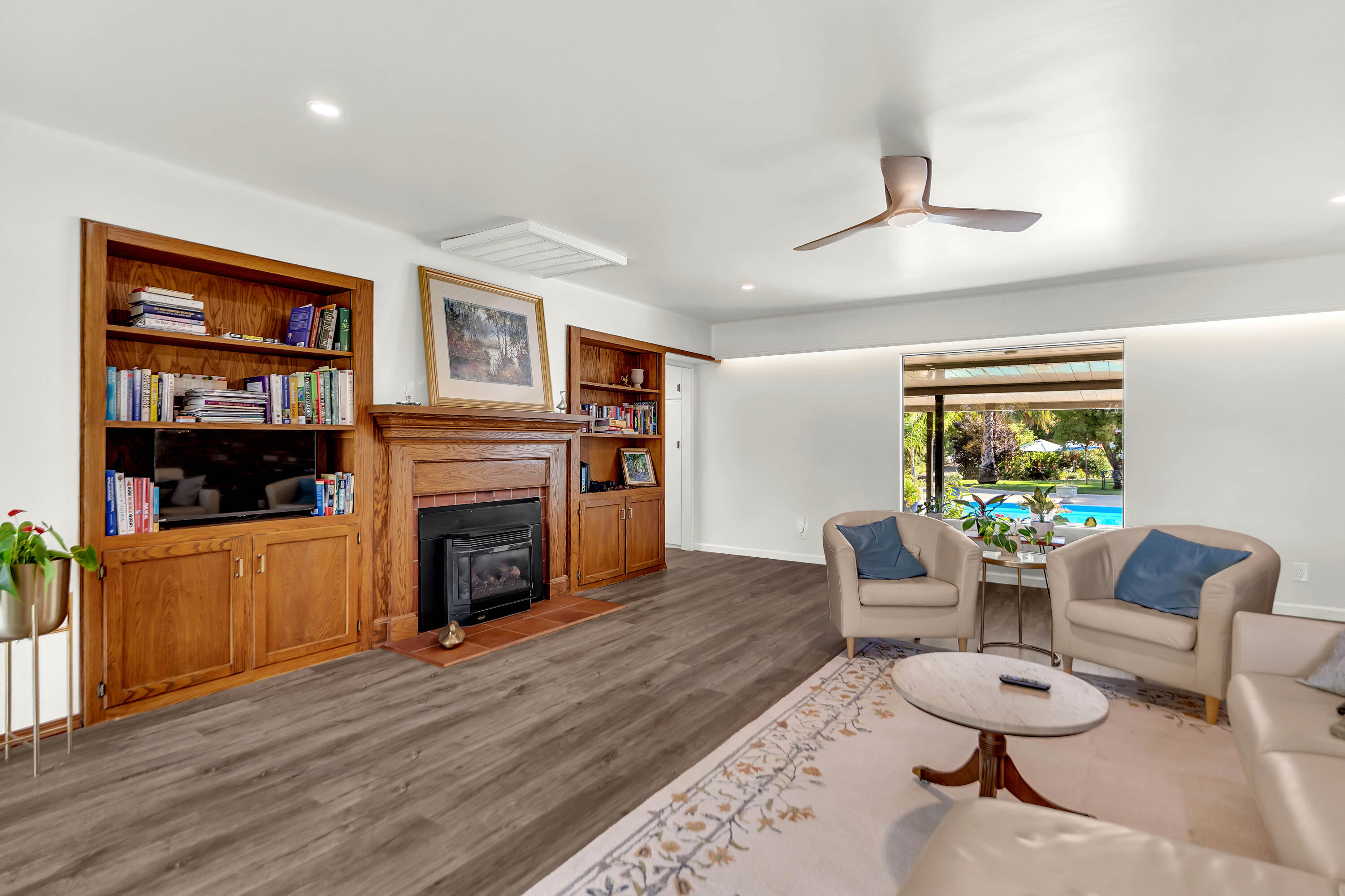 195 Howell Avenue Red Bluff, CA 96080 - Photo 16 of 66 a living room with furniture a fireplace and a flat screen tv
