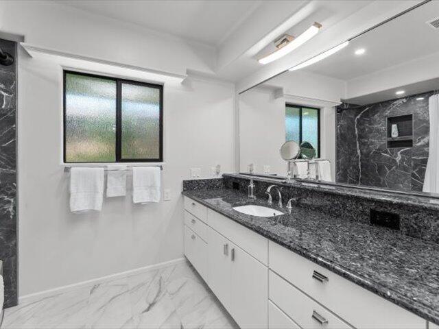 195 Howell Avenue Red Bluff, CA 96080 - Photo 24 of 66 a bathroom with a granite countertop sink and a mirror