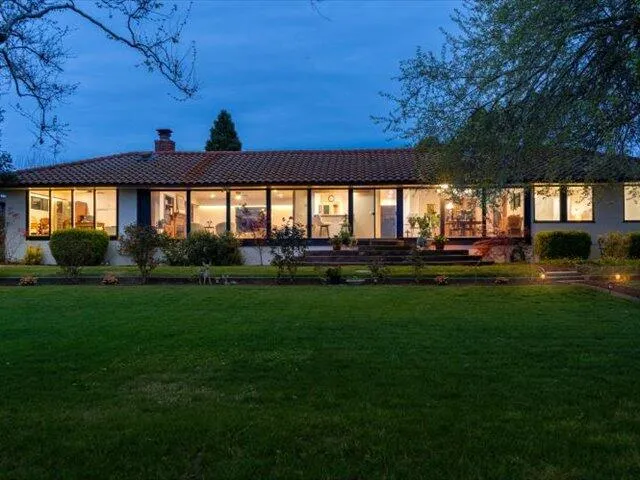 a view of a house with backyard sitting area and garden
