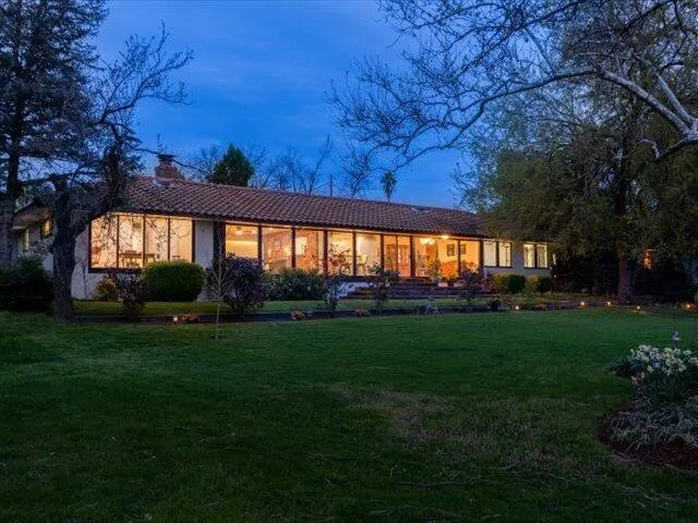 a view of a house with potted plants