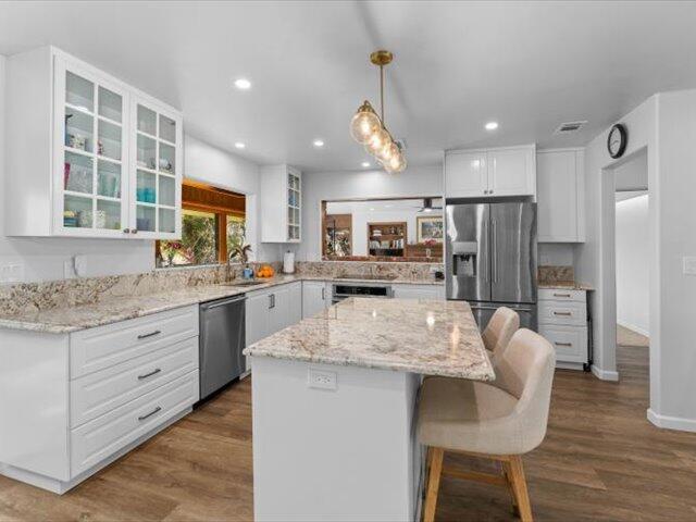 195 Howell Avenue Red Bluff, CA 96080 - Photo 8 of 66 a kitchen with stainless steel appliances granite countertop refrigerator stove microwave and cabinets