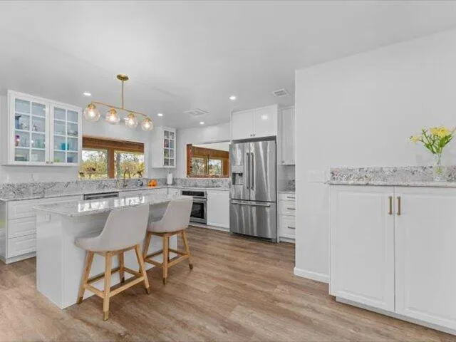 a view of granite countertop wooden floor and a window