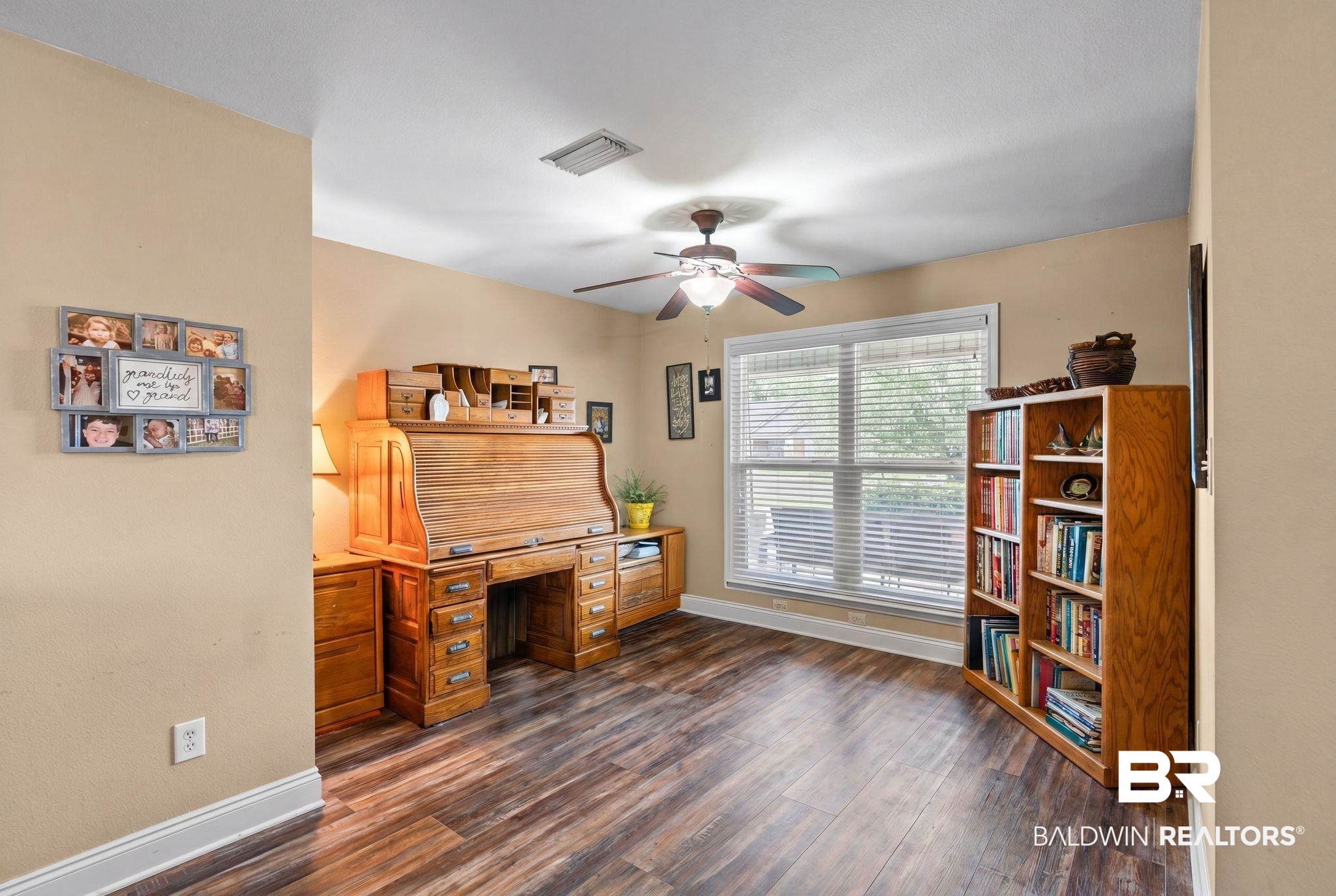 562 Vestige Mews Foley, AL 36535 - Photo 14 of 54 Spacious room featuring wood-finish flooring, a ceiling fan with integrated lighting, a large window with blinds, and neutral wall tones