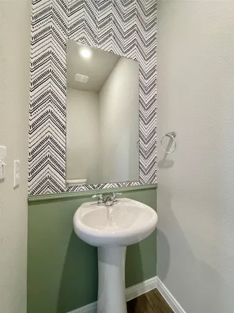 a bathroom with a sink and mirror