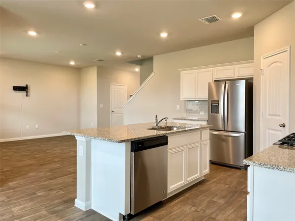 a kitchen with a sink stainless steel appliances and cabinets