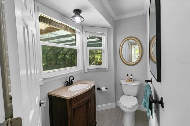 a kitchen with stainless steel appliances kitchen island a stove a refrigerator and a refrigerator with wooden floor