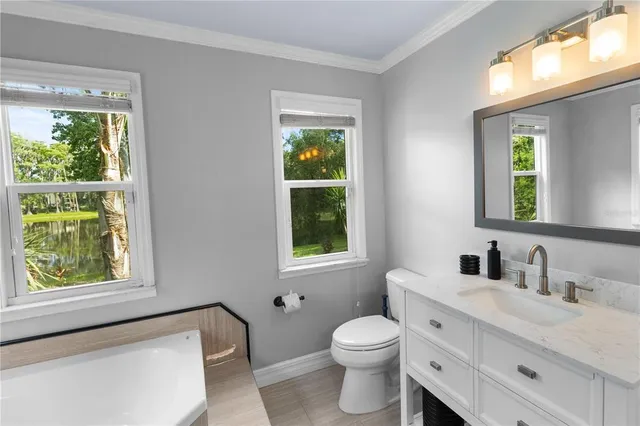 an empty room with a window and a ceiling fan