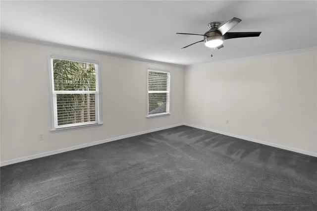 a backyard of a house with lots of green space and lake view