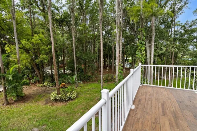 an aerial view of a house with a yard and tree s