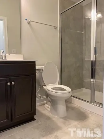 a bathroom with a toilet a sink and shower