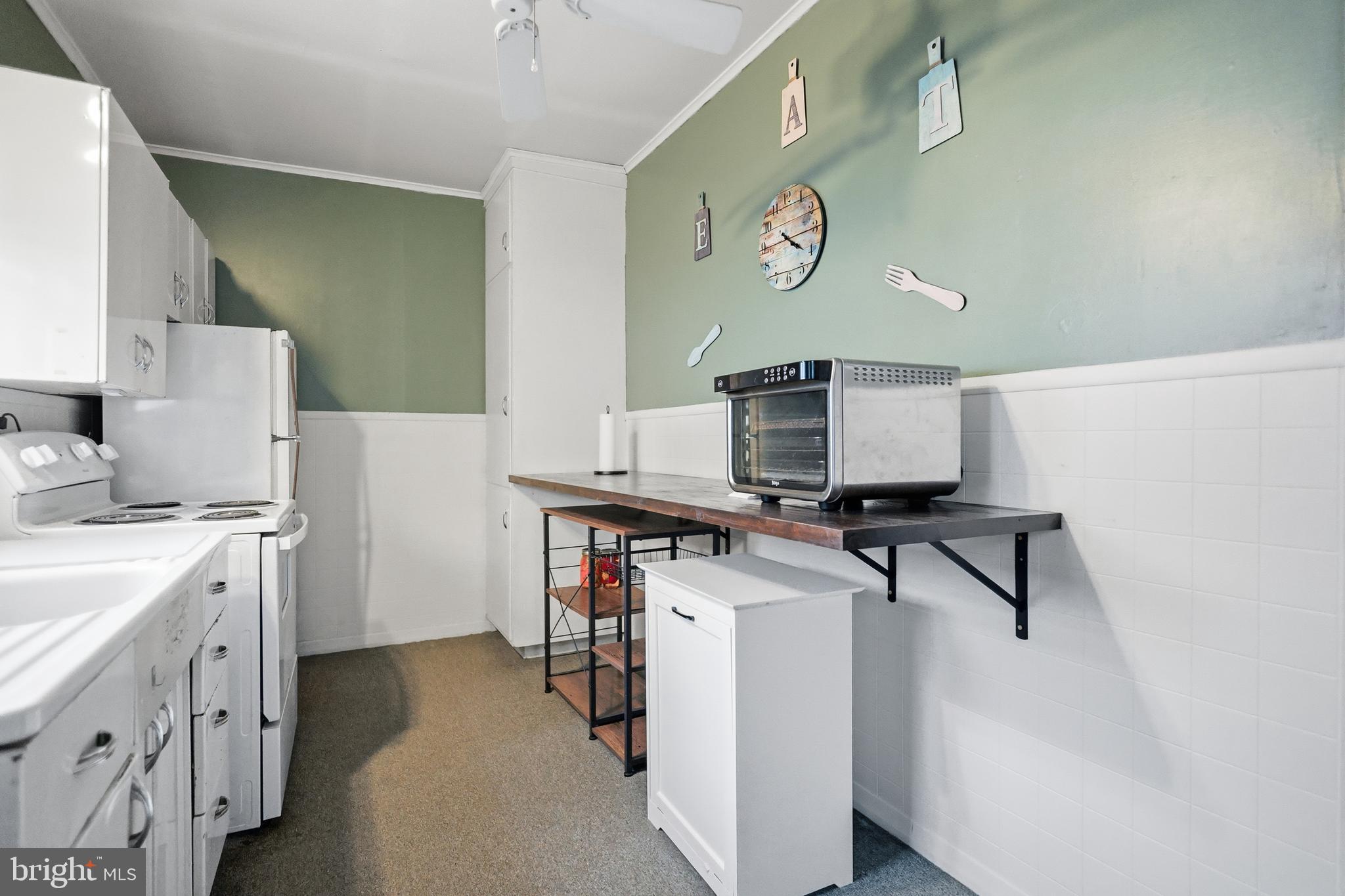 728 East Broad Street Tamaqua, PA 18252 - Photo 11 of 26 a kitchen with stainless steel appliances a stove refrigerator sink and cabinets