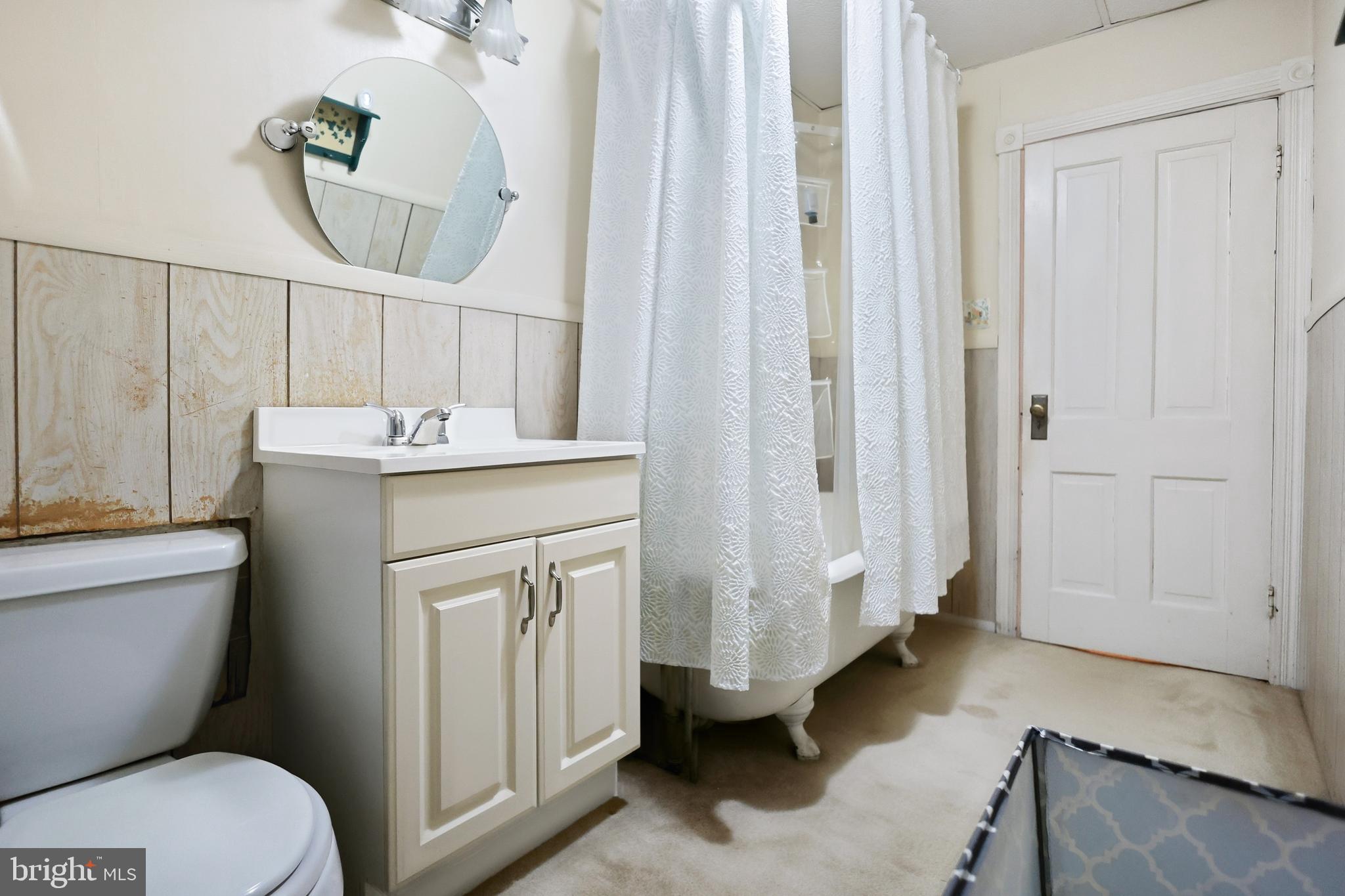 728 East Broad Street Tamaqua, PA 18252 - Photo 15 of 26 a bathroom with a sink a toilet and a mirror