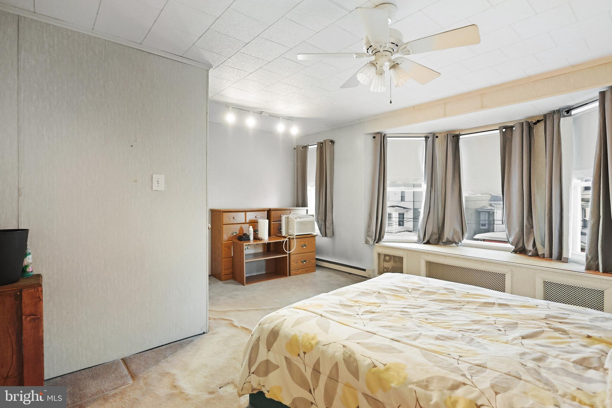 728 East Broad Street Tamaqua, PA 18252 - Photo 18 of 26 a bedroom with a large bed and a chandelier