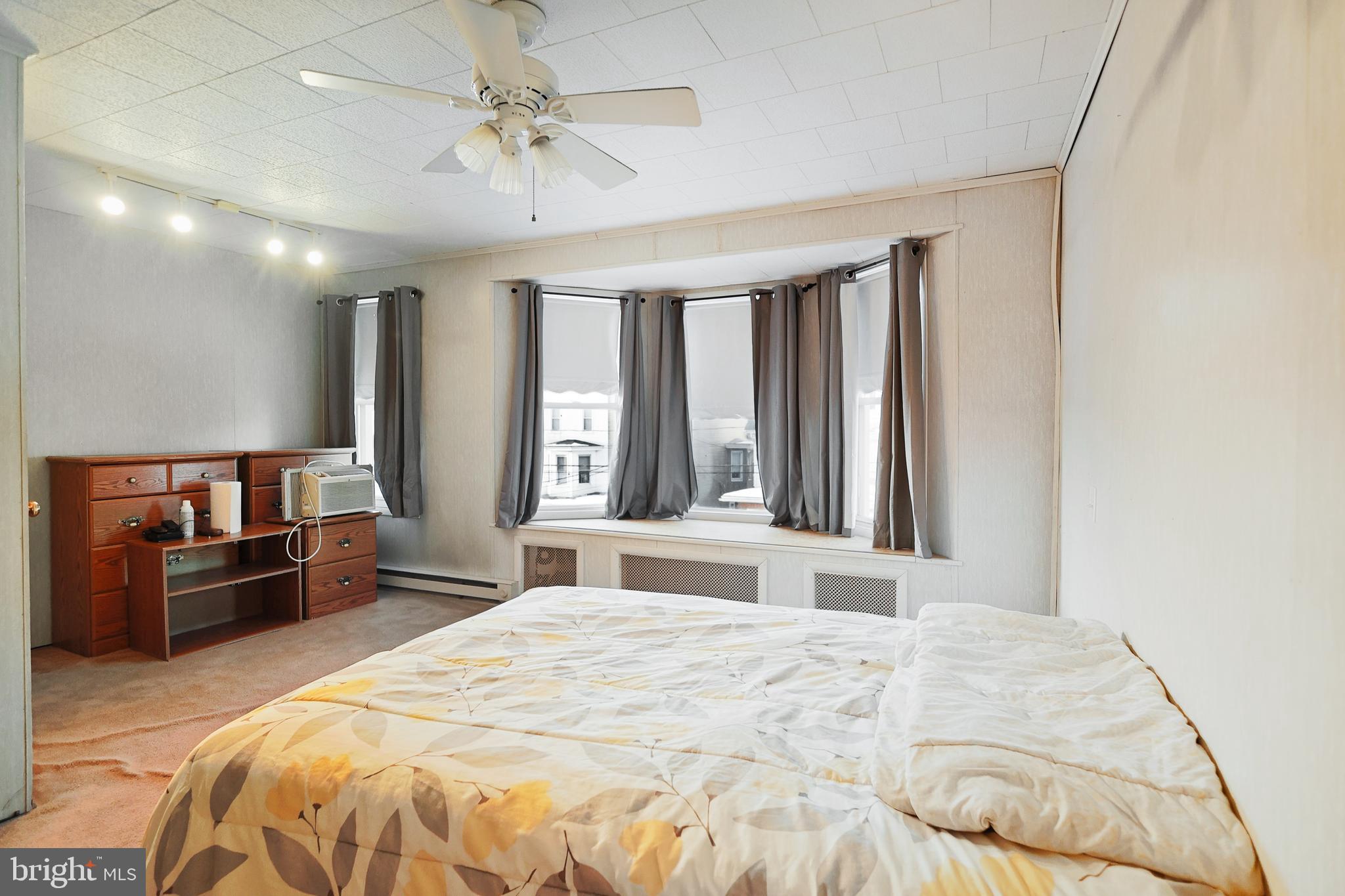 728 East Broad Street Tamaqua, PA 18252 - Photo 20 of 26 a bedroom with a large bed and a chandelier