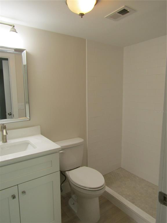 999 Inlet Circle, Unit D101 Venice, FL 34285 - Photo 17 of 29 a bathroom with a sink a toilet and mirror