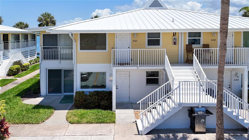 999 Inlet Circle, Unit D101 Venice, FL 34285 - Photo 2 of 29 a front view of a house with a yard