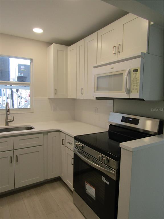 999 Inlet Circle, Unit D101 Venice, FL 34285 - Photo 5 of 29 a kitchen with cabinets stainless steel appliances and a sink