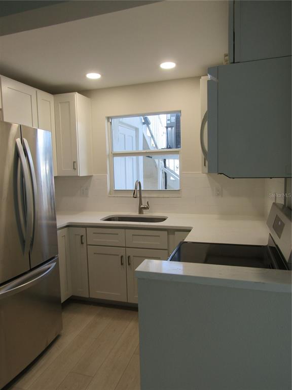 999 Inlet Circle, Unit D101 Venice, FL 34285 - Photo 6 of 29 a kitchen with stainless steel appliances granite countertop a refrigerator sink and cabinets