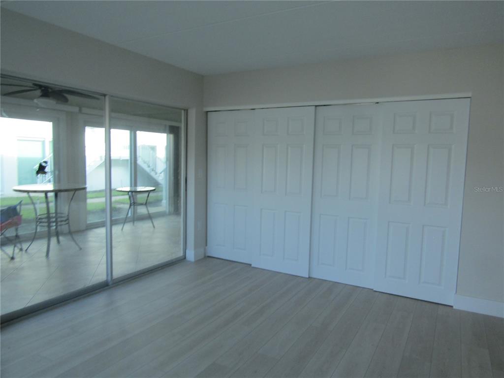 999 Inlet Circle, Unit D101 Venice, FL 34285 - Photo 9 of 29 an empty room with sliding glass door and shower