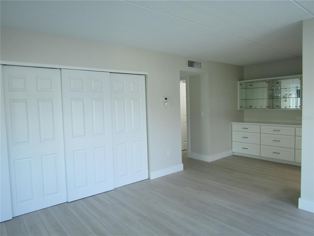 999 Inlet Circle, Unit D101 Venice, FL 34285 - Photo 10 of 29 a view of a dresser with wooden floor