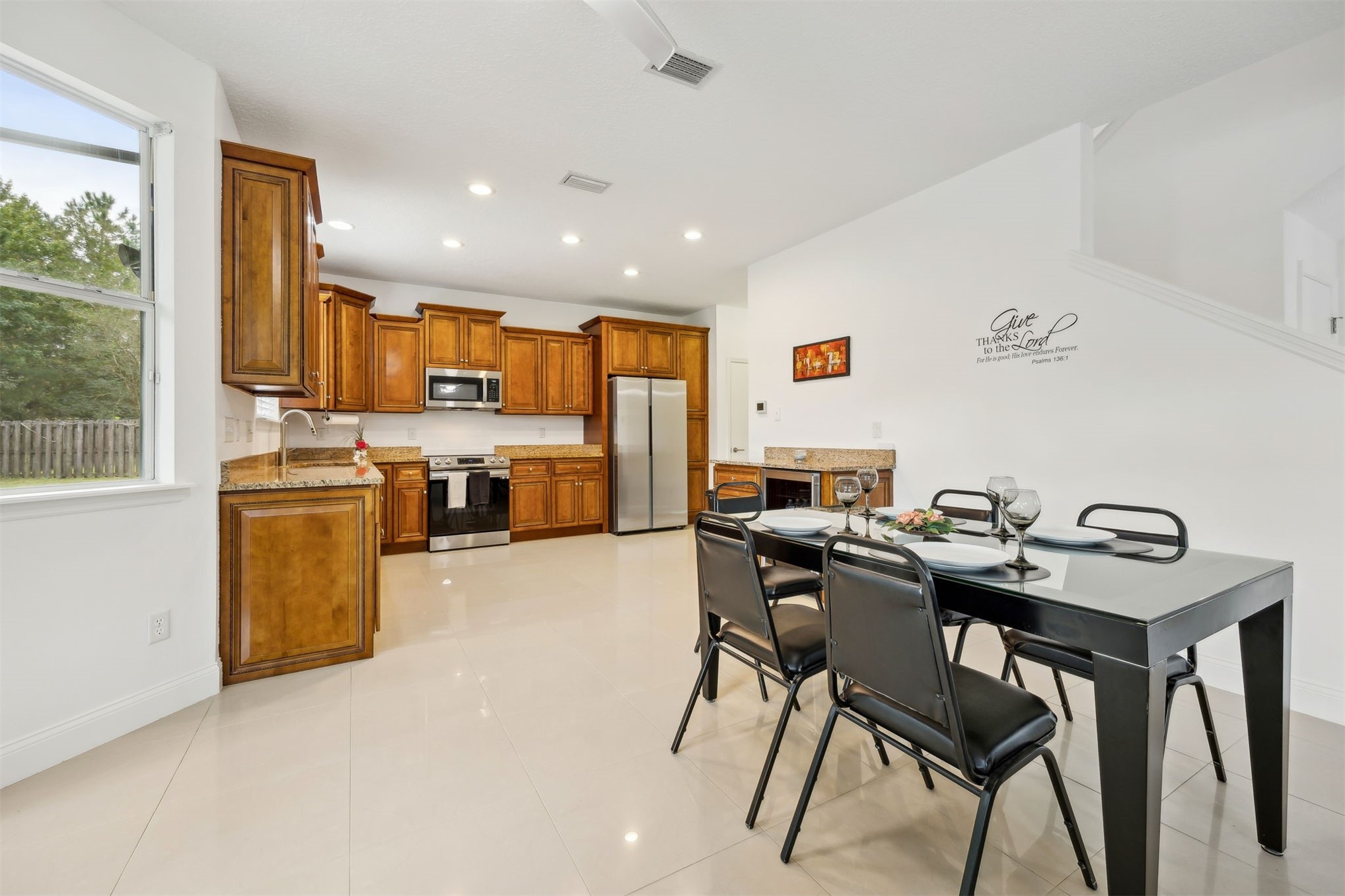 76002 Tideview Lane Yulee, FL 32097 - Photo 14 of 58 a view of kitchen with kitchen island a stove a table and chairs in it