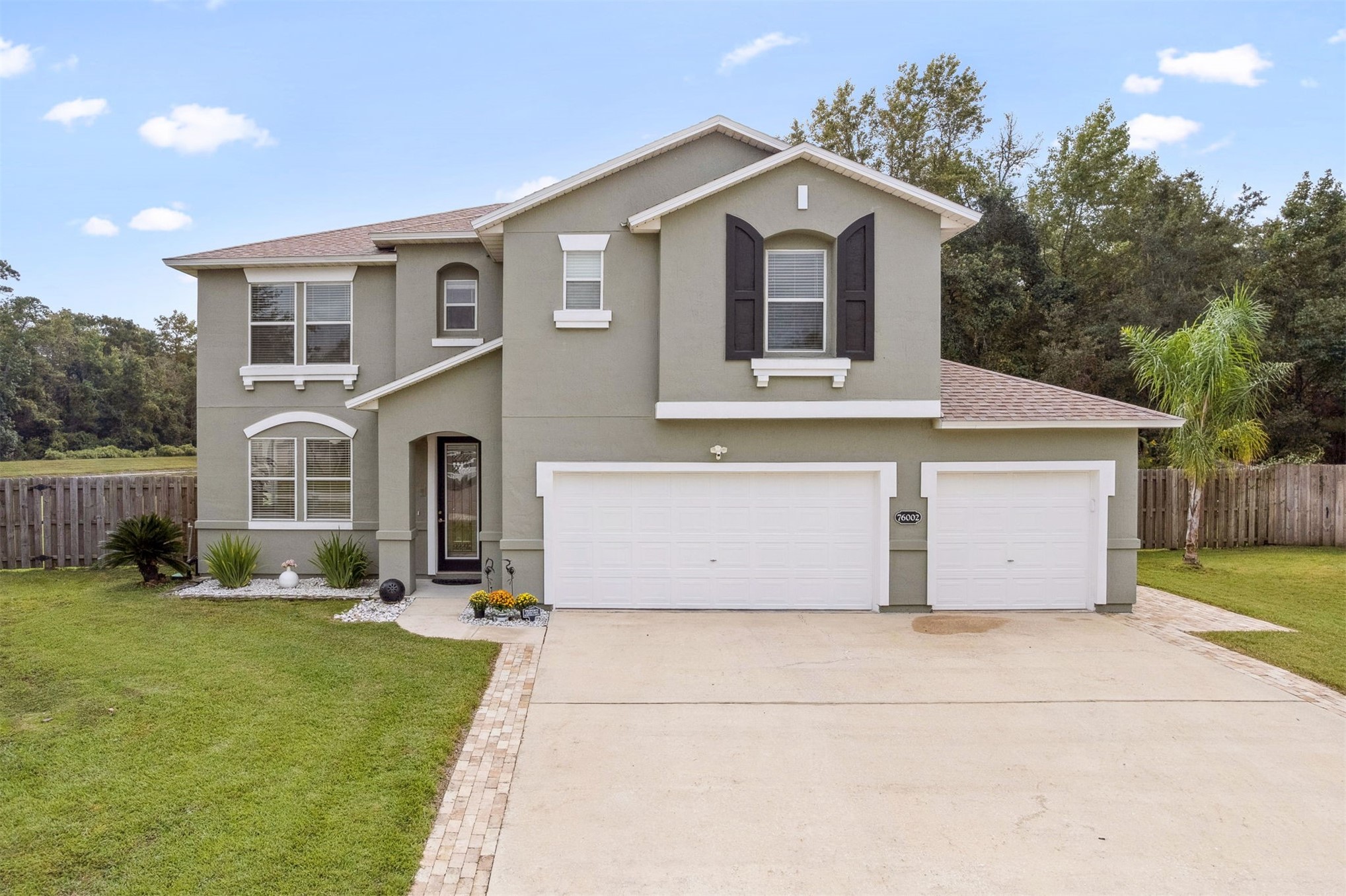 76002 Tideview Lane Yulee, FL 32097 - Photo 2 of 58 a front view of a house with a yard