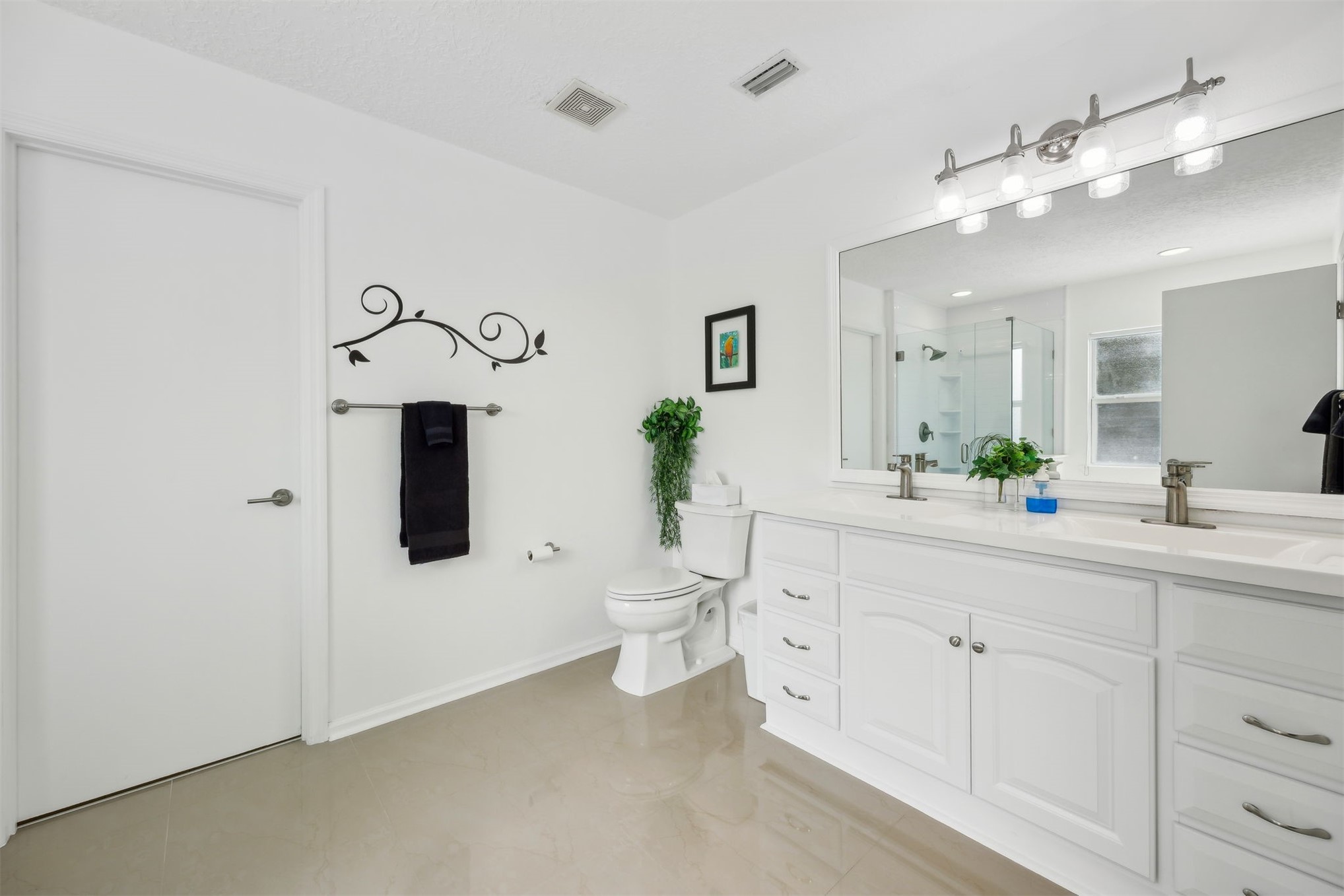 76002 Tideview Lane Yulee, FL 32097 - Photo 24 of 58 a spacious bathroom with a toilet sink and mirror