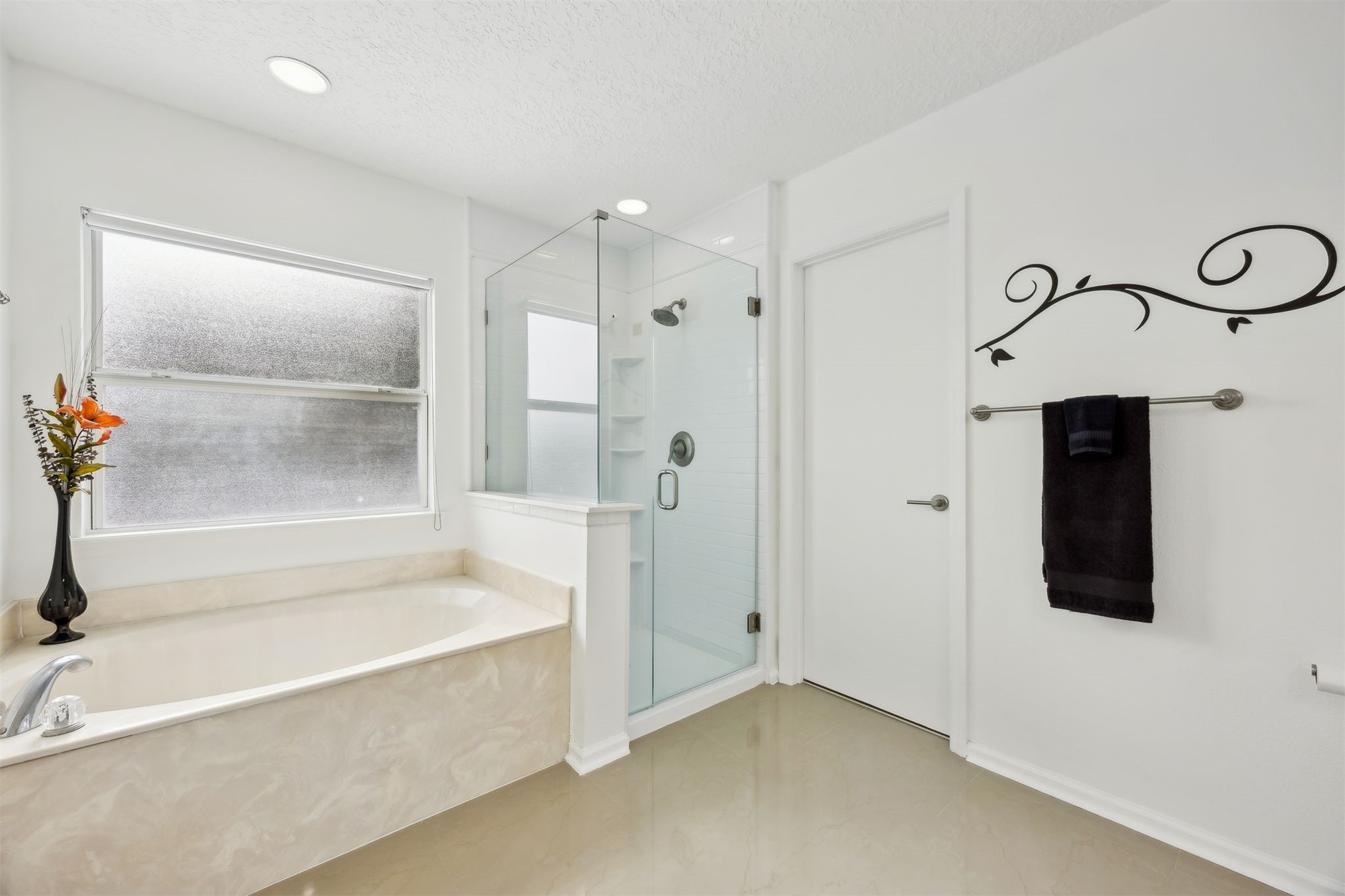 76002 Tideview Lane Yulee, FL 32097 - Photo 25 of 58 a bathroom with a bathtub and a shower