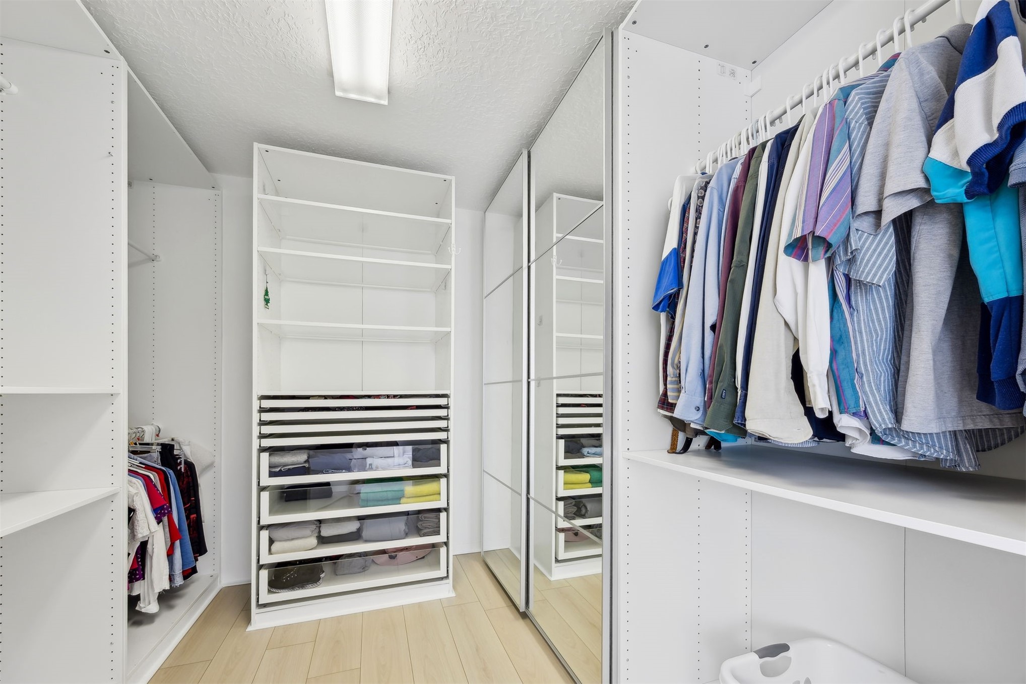 76002 Tideview Lane Yulee, FL 32097 - Photo 26 of 58 a view of walk in closet with clothes and shoes