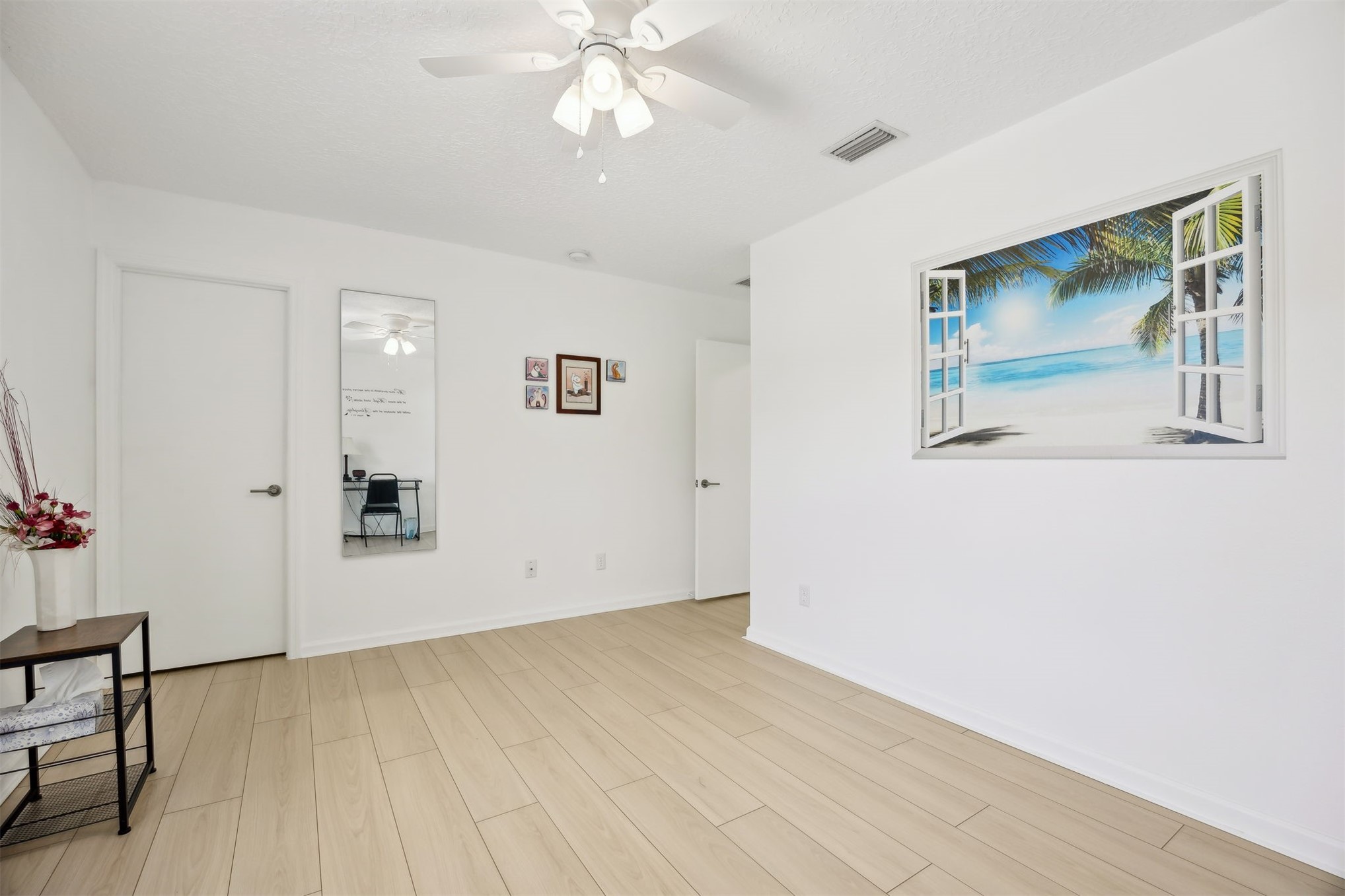 76002 Tideview Lane Yulee, FL 32097 - Photo 29 of 58 a view of an empty room with wooden floor and a chandelier fan