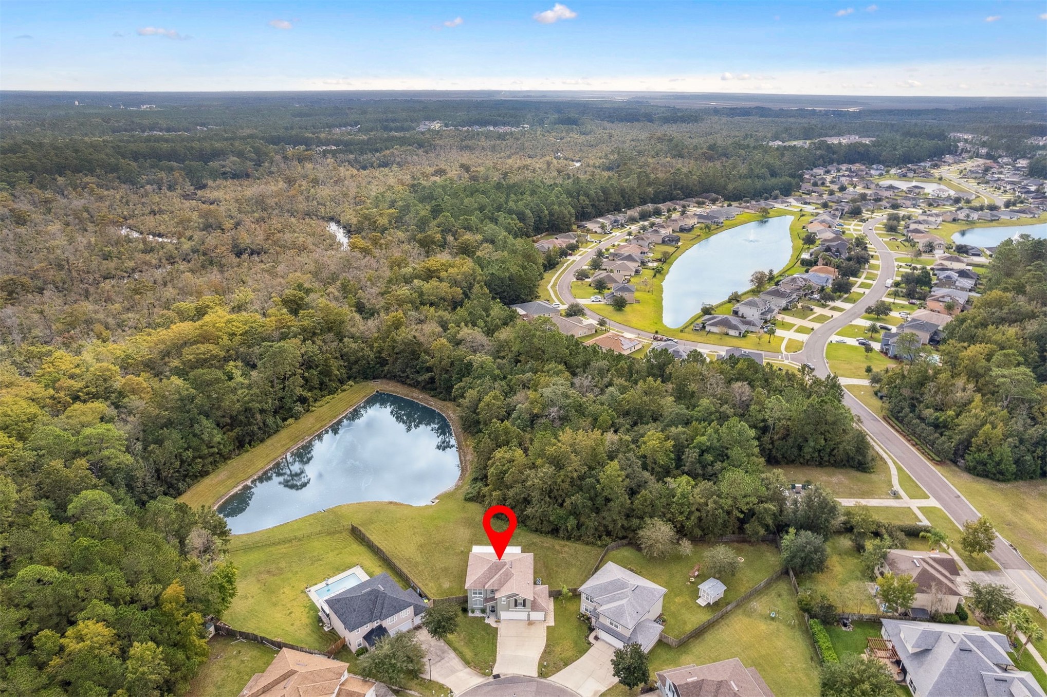 76002 Tideview Lane Yulee, FL 32097 - Photo 47 of 58 an aerial view of a house with a swimming pool and lake view