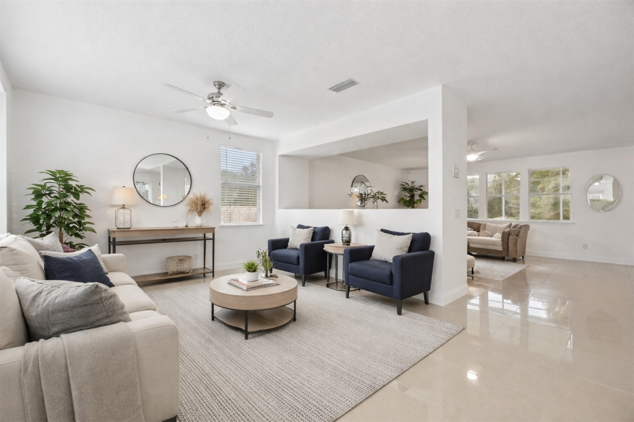 76002 Tideview Lane Yulee, FL 32097 - Photo 5 of 58 a living room with furniture a clock and a chandelier