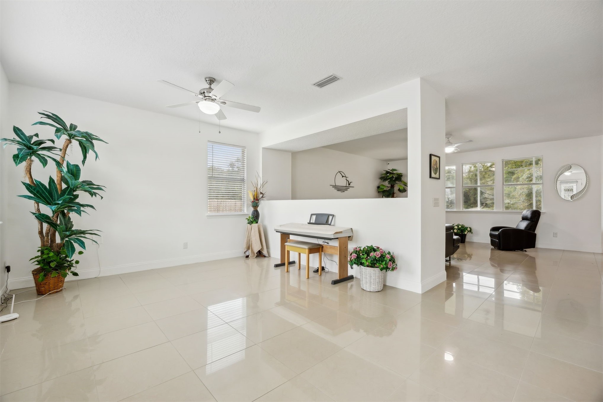 76002 Tideview Lane Yulee, FL 32097 - Photo 6 of 58 a living room with furniture and a chandelier