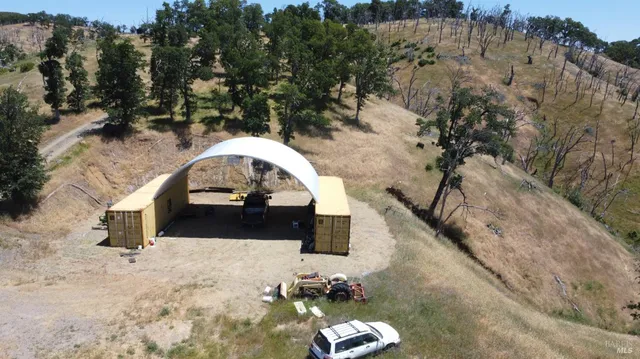 a view of a mountain with a field