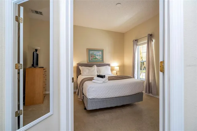 a bedroom with a bed and a couch