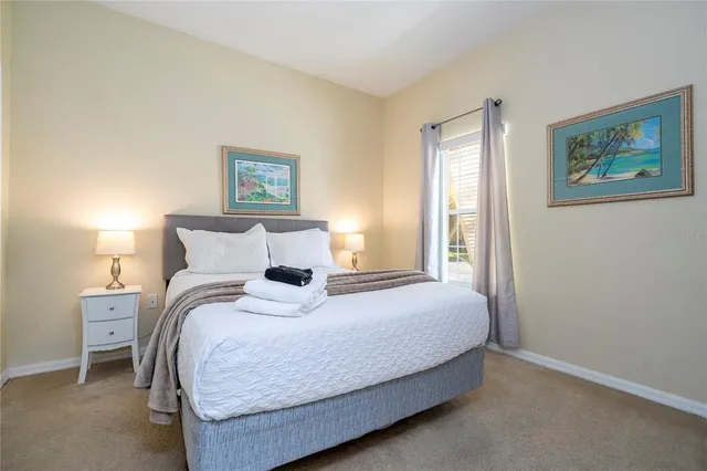 a bedroom with a bed and painting on the wall